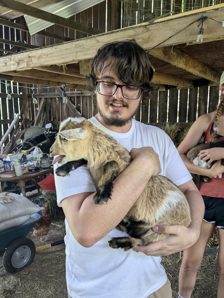 Andy holding a goat in Jackson County